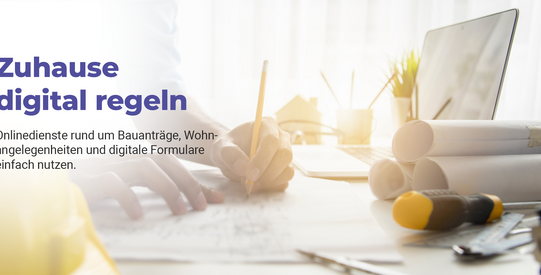 Bauplaner zeichnet an einer Skizze, daneben liegen Baupläne, Laptop und weitere Werkzeuge